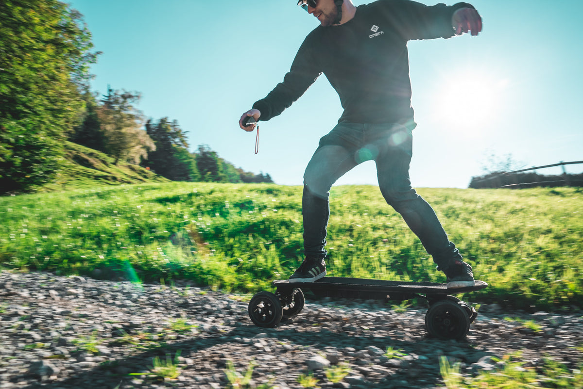 Rider on the ONSRA Challenger Pro All-Terrain on a grassy hill