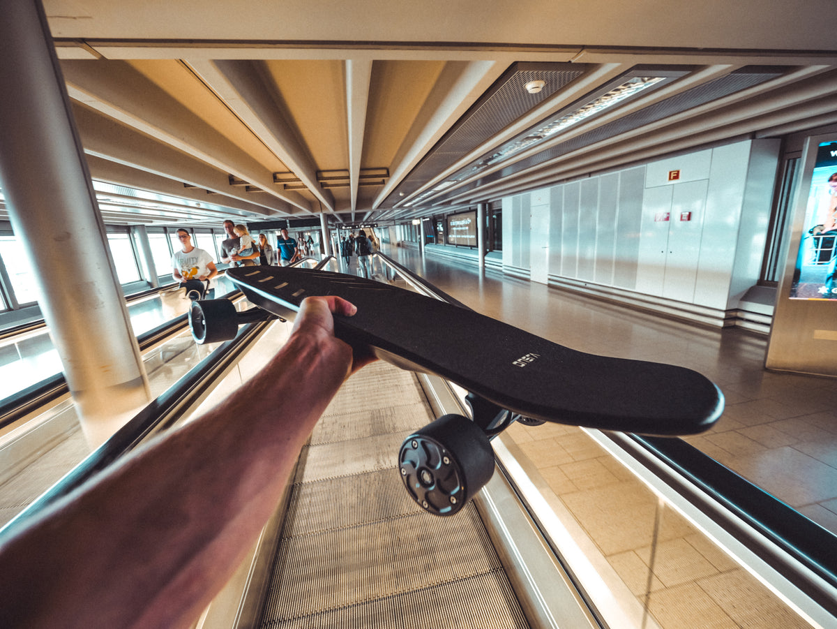 ONSRA ZENO on an airport moving walkway