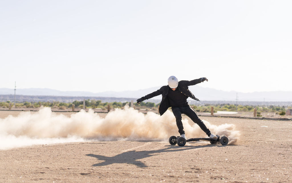 Rider sliding an ONSRA VELAR on a dirt track