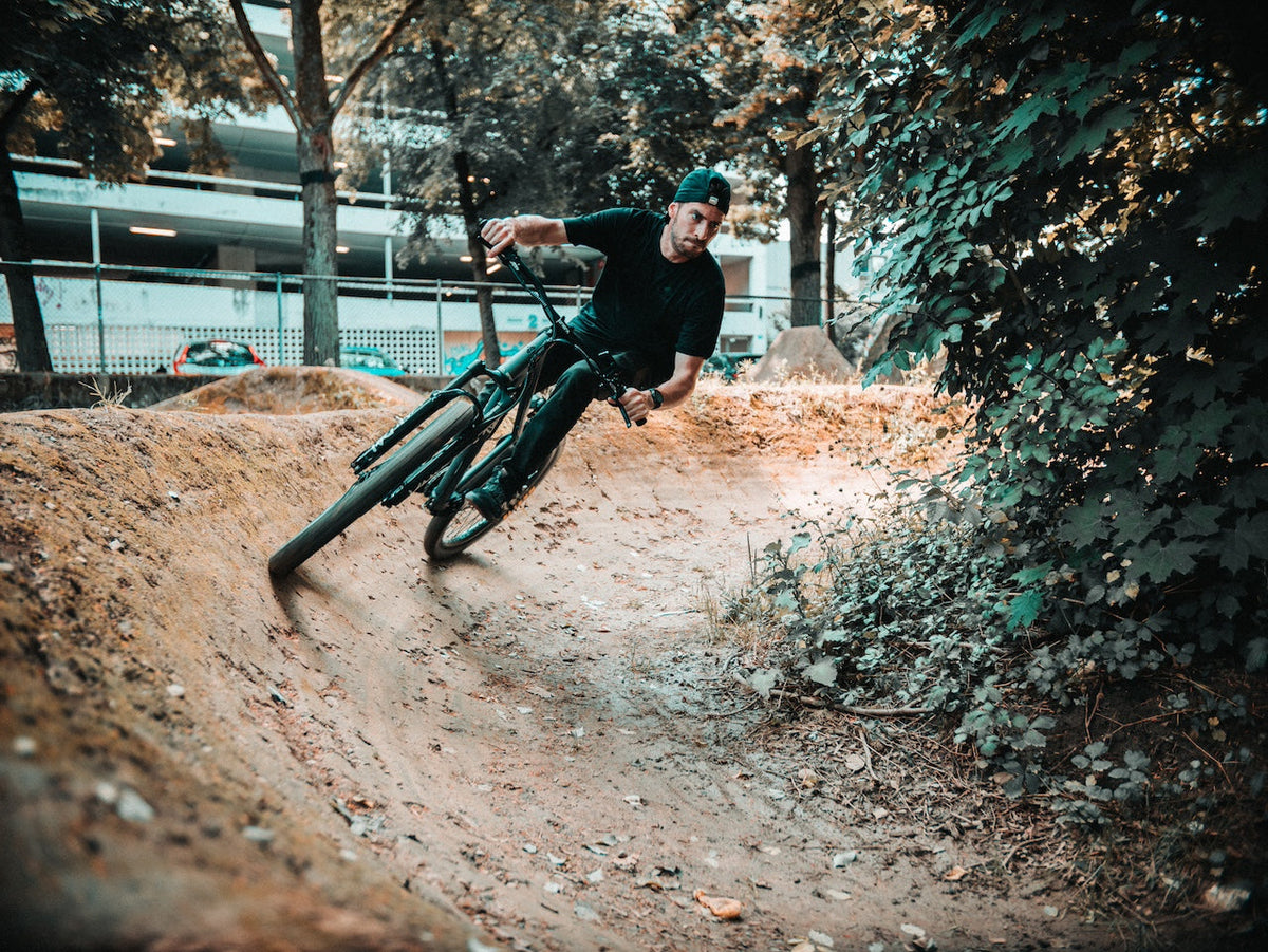 Rider cornering an ONSRA VANDAL electric bike on a dirt track